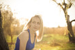 Beautiful blonde girl model looks away in the sun rays