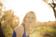 Beautiful blonde girl model looks away in the sun rays