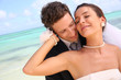 Just married couple standing on a paradisiacal beach