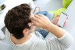 Upper view of man in sofa using smartphone
