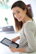 Young cheerful woman using digital tablet