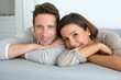 Portrait of sweet couple sitting in sofa