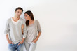 Young couple standing on white background