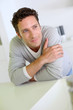 Portrait of handsome man leaning on kitchen counter