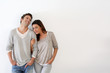 Young couple standing on white background