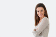 Photo: Girl with arms crossed standing on white background Girl with arms crossed standing on white background
