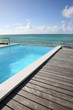 Beautiful view of infinity pool with wooden deck