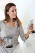 Young woman at home connected on smartphone