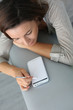 Photo: Young woman using smartphone at home Young woman using smartphone at home