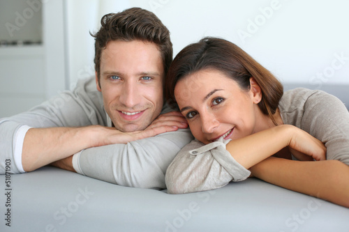 Photo: Portrait of sweet couple sitting in sofa Portrait of sweet couple sitting in sofa
