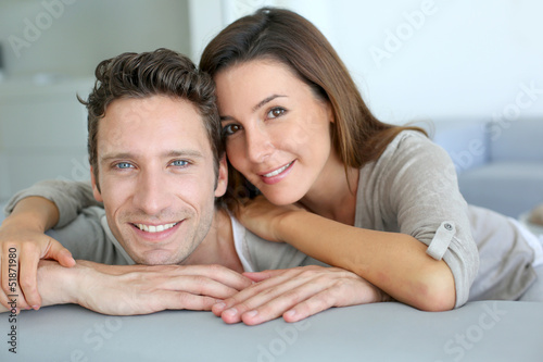 Photo: Portrait of sweet couple sitting in sofa Portrait of sweet couple sitting in sofa