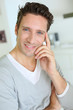 Photo: Smiling handsome guy with hand on chin Smiling handsome guy with hand on chin