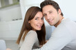 Portrait of sweet couple sitting in sofa