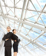 young businessman and businesswoman stand in the modern office