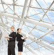 Photo: young business man and woman holding laptop and stand in the mod young business man and woman holding laptop and stand in the mod