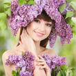 Young woman with lilac flowers