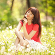 Cute woman in the park with dandelions