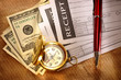 Blank receipt, money, compass and pen