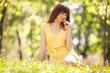 Photo: Cute woman in the park with dandelions Cute woman in the park with dandelions