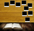 Illustration: Reading book with photo frames post on wooden wall, Reading tabl Reading book with photo frames post on wooden wall, Reading tabl