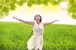 Attractive woman celebrate spring in green field