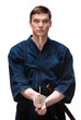 Kendoka in hakama keeps bokken, isolated on white
