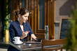 businesswoman with credit card and laptop sitting at a table in
