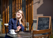 businesswoman with credit card and laptop sitting at a table in