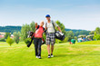 Young sportive couple playing golf on a course