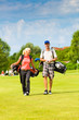 Young sportive couple playing golf on a course