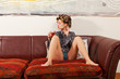 sexy girl drinking a drink on the couch