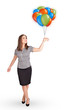 Young woman holding colorful balloons