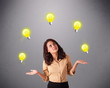 Photo: young lady standing and juggling with light bulbs young lady standing and juggling with light bulbs