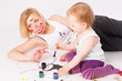 Pretty young mother and daughter drawing