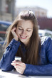 Young woman reading a message on the phone