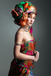 Photo of beautiful girl in a head-dress from the coloured fabric