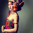 Photo of beautiful girl in a head-dress from the coloured fabric