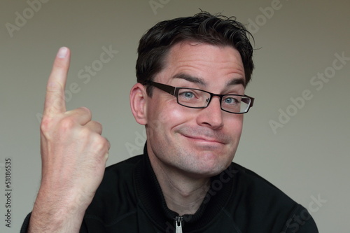 Photo: Attractive caucasian man with glasses pointing up Attractive caucasian man with glasses pointing up