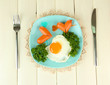 Sausages in form of hearts, scrambled eggs and parsley,
