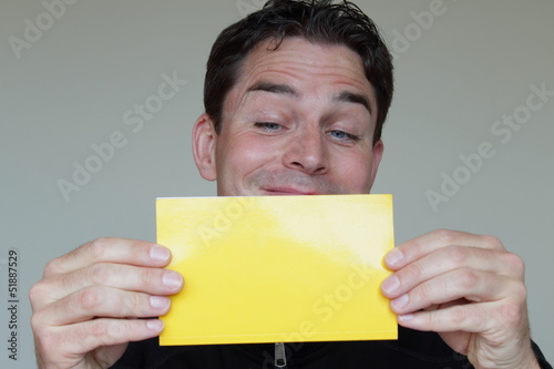 Photo: Caucasian man directing attention to a space for advertisement Caucasian man directing attention to a space for advertisement