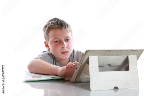 Photo: boy with tablet computer makes lessons boy with tablet computer makes lessons