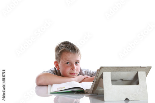 Photo: boy with tablet computer makes lessons boy with tablet computer makes lessons