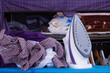 Iron with Mix of Clothes Against Wardrobe