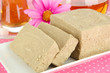 Tasty halva with tea on table close-up