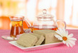 Tasty halva with tea on table in room