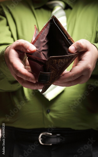 Photo: Empty wallet in male hands - poor economy Empty wallet in male hands - poor economy