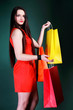 young woman with paper multi coloured shopping bag