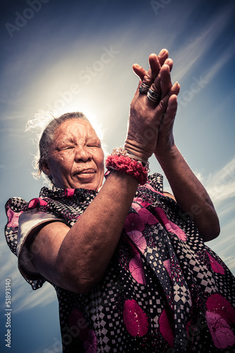 Photo: Coloured woman praying for better days Coloured woman praying for better days