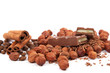 Stack of chocolate tiles with hazelnuts and cinnamon sticks on a