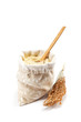 Flour in a bag with wooden spoon isolated on a white background.